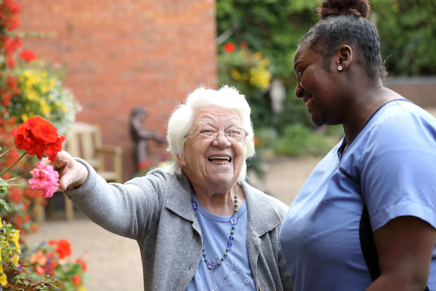 CCH About image depicting a resident laughing with a carer