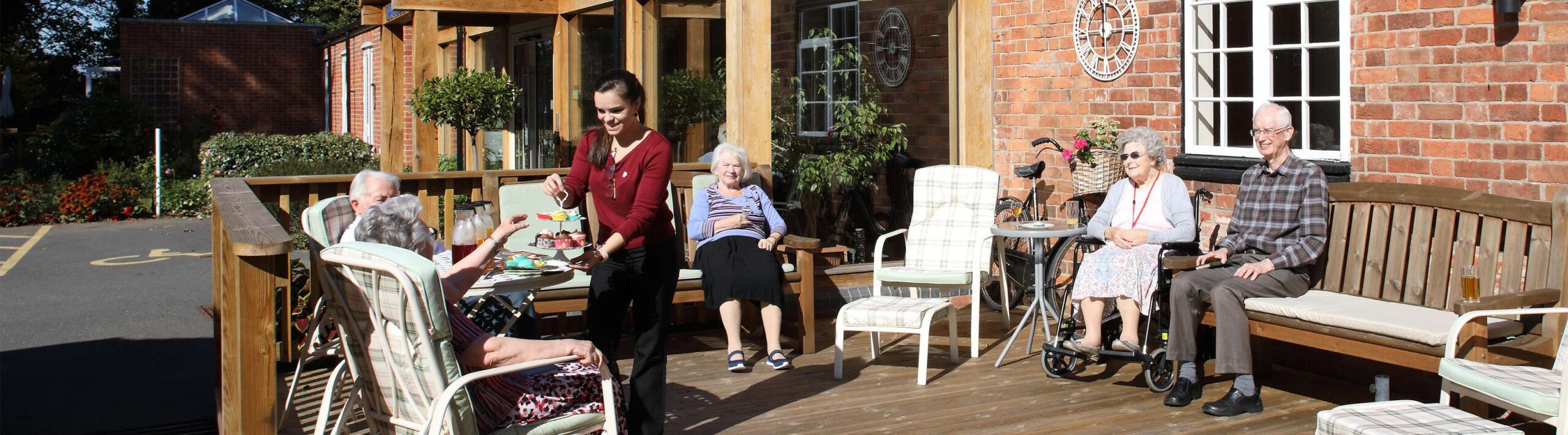 CCH Image showing a collection of residents sat outside eating lunch