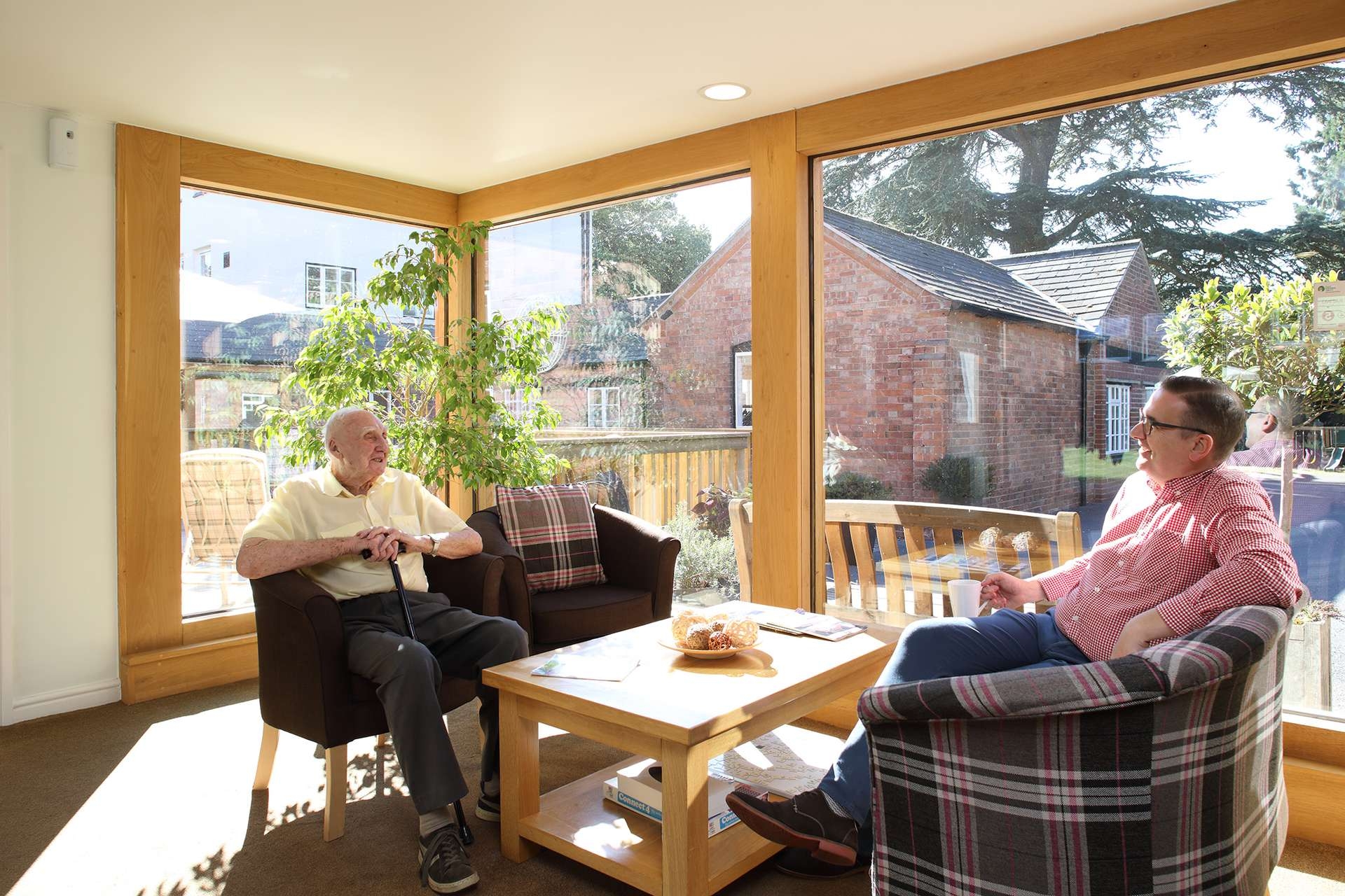 CCH Image displaying residents sat in the conservatory