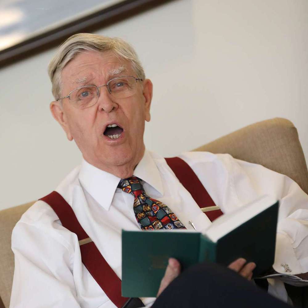 CCH Image of a resident reading a book with a green cover