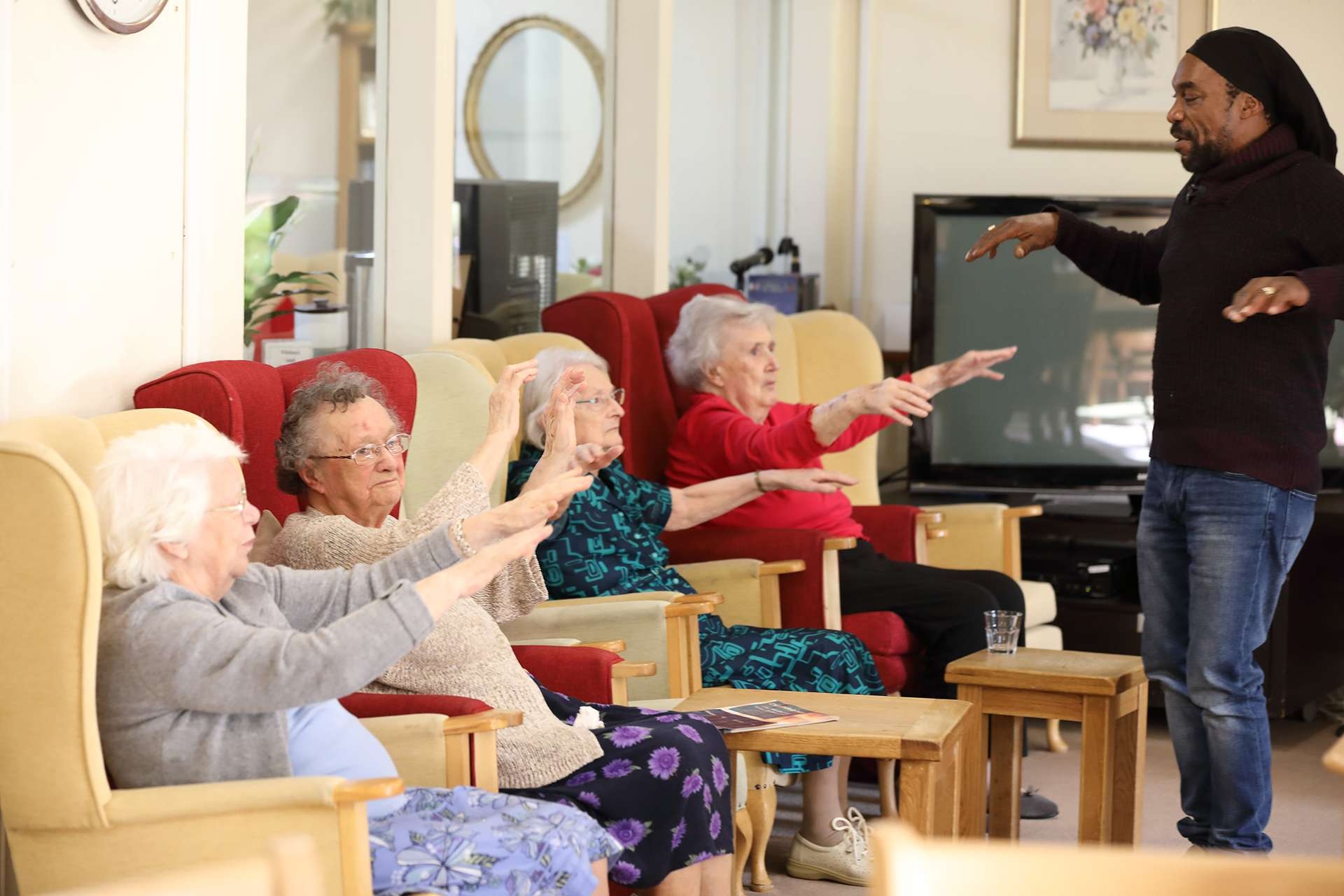 CCH Kingsleigh Gallery Image showing residents sat down waving their arms